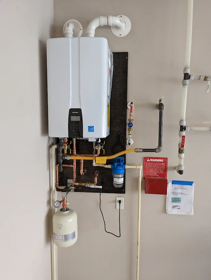 Professional plumber installing copper piping in a Lake Butler home